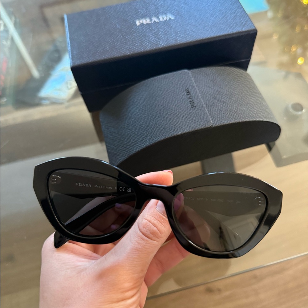 Prada Black Sunglasses with Cat-Eye Frame and Dark Lenses